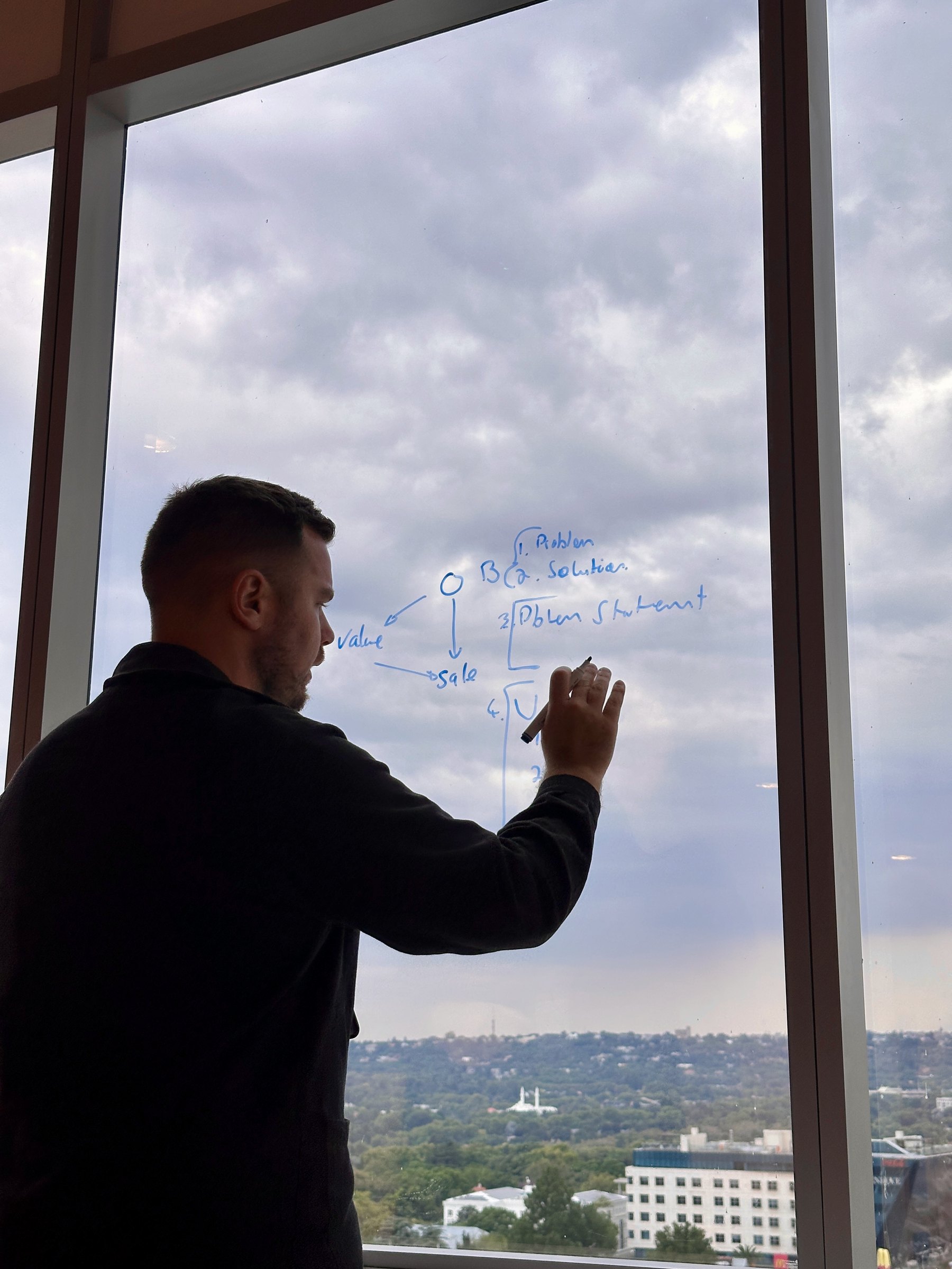 Thinking it through on the glass, Joburg behind