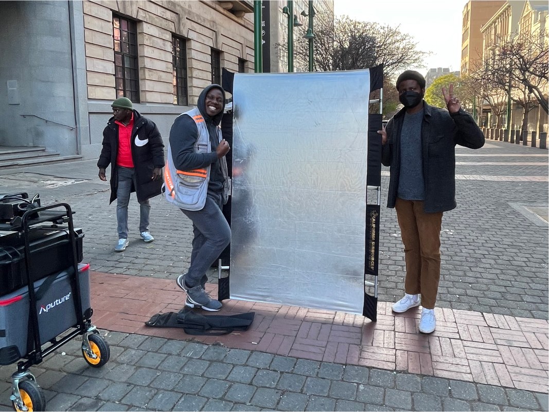 Bouncing light off a reflector on a Joburg street shoot