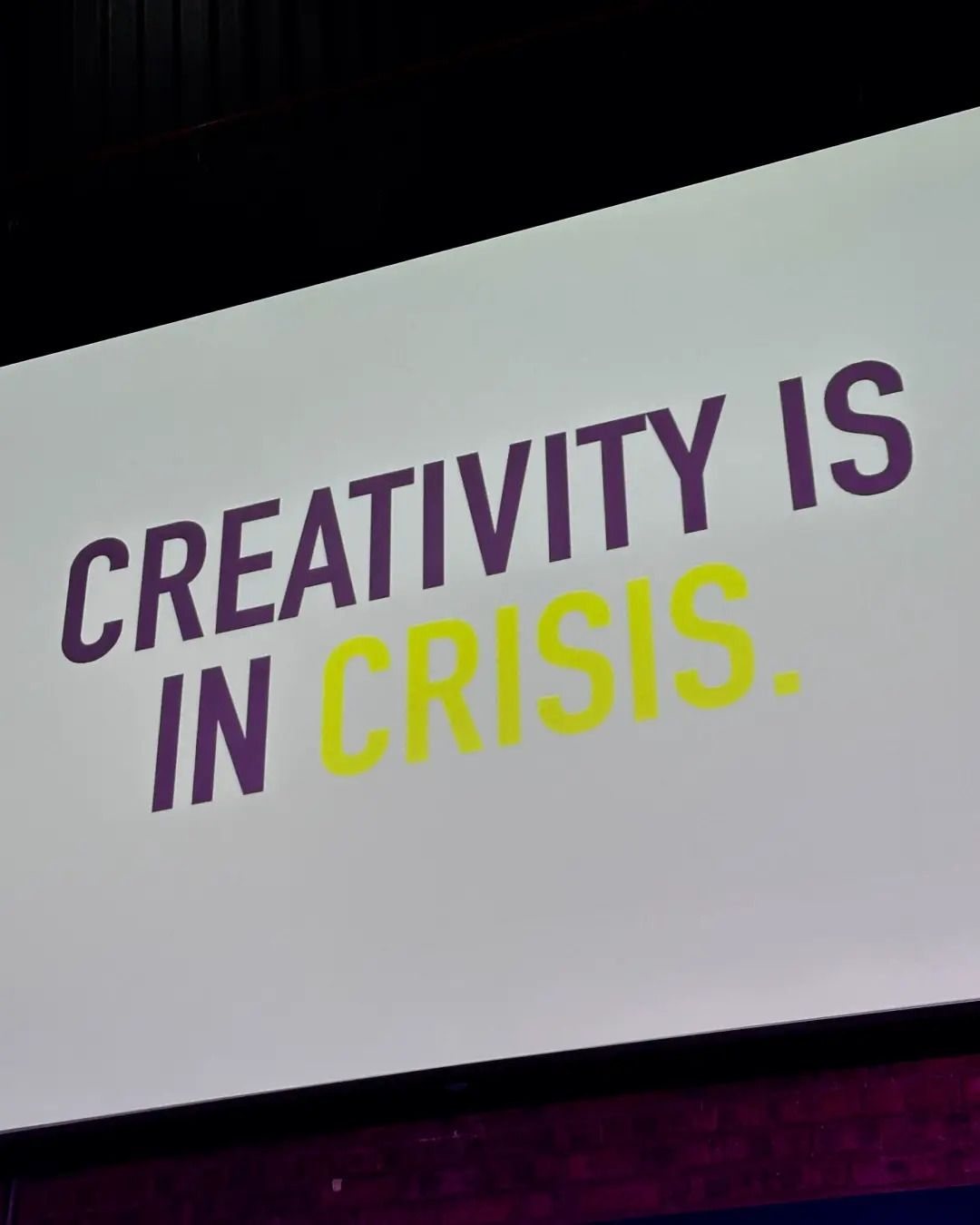 A stage screen at the 27 Breakfast reading ‘Creativity is in crisis’